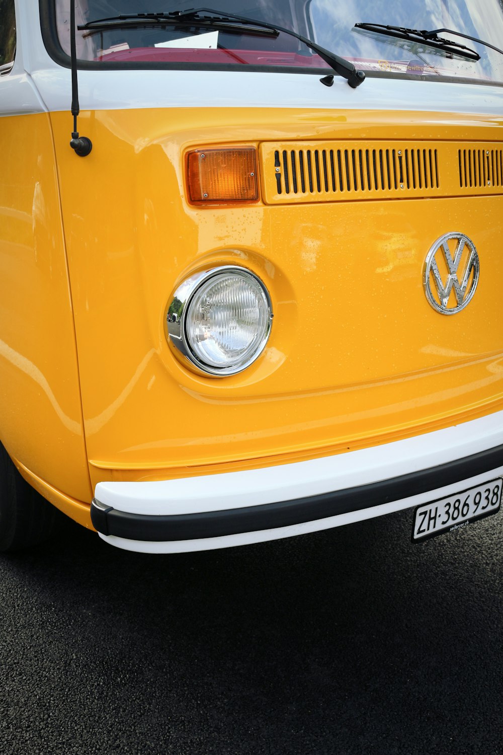 a yellow vw bus parked in a parking lot