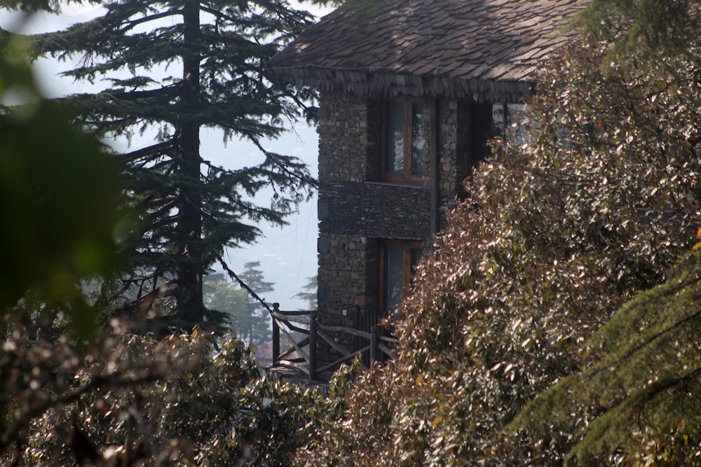 a stone building surrounded by trees and bushes