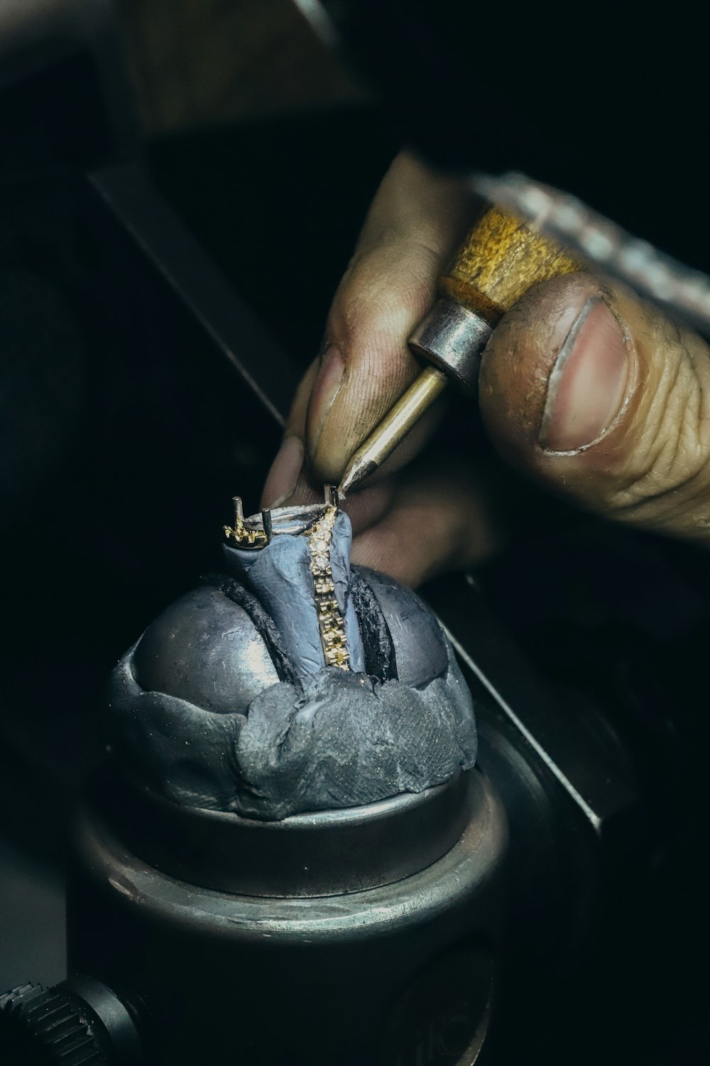 a person working on a shoe with a tool