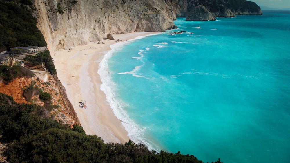 a view of a beach with a cliff in the background