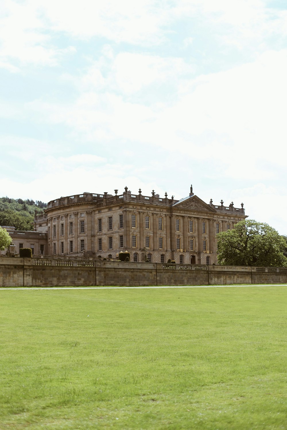 a large building sitting on top of a lush green field