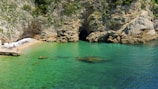 a body of water with a cave in the middle of it