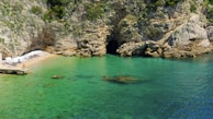 a body of water with a cave in the middle of it