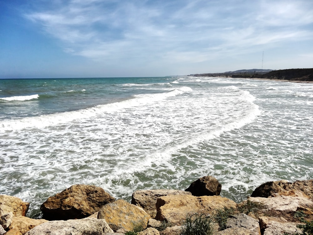 a view of the ocean from a rocky shore