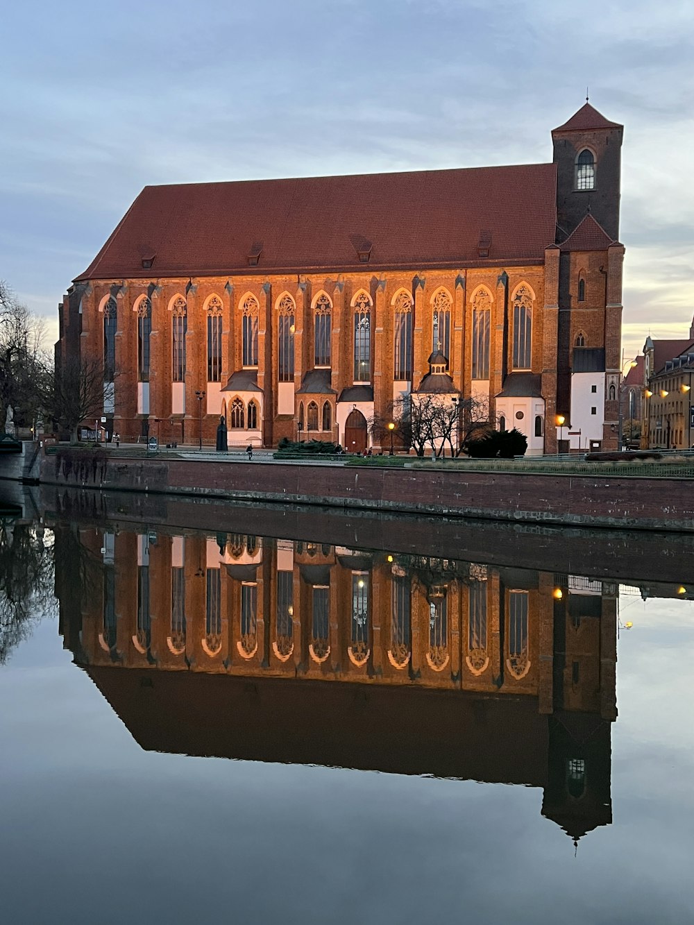 a large building with a clock tower next to a body of water
