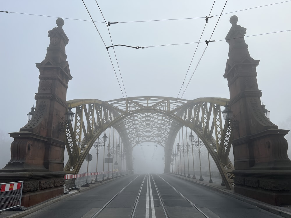 a foggy day on a bridge with power lines above