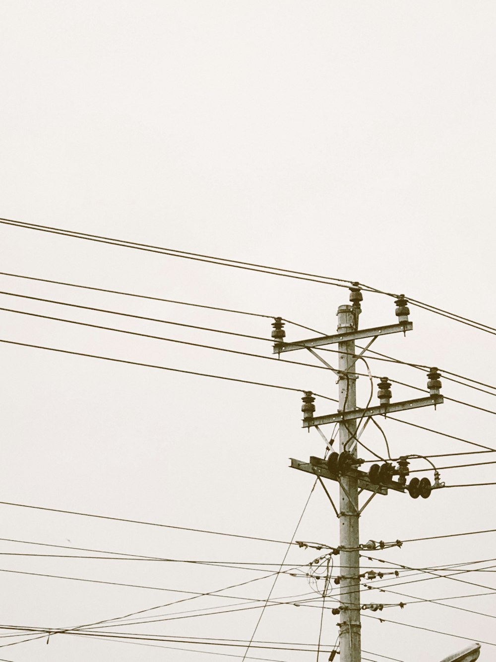 a telephone pole with a bunch of wires above it