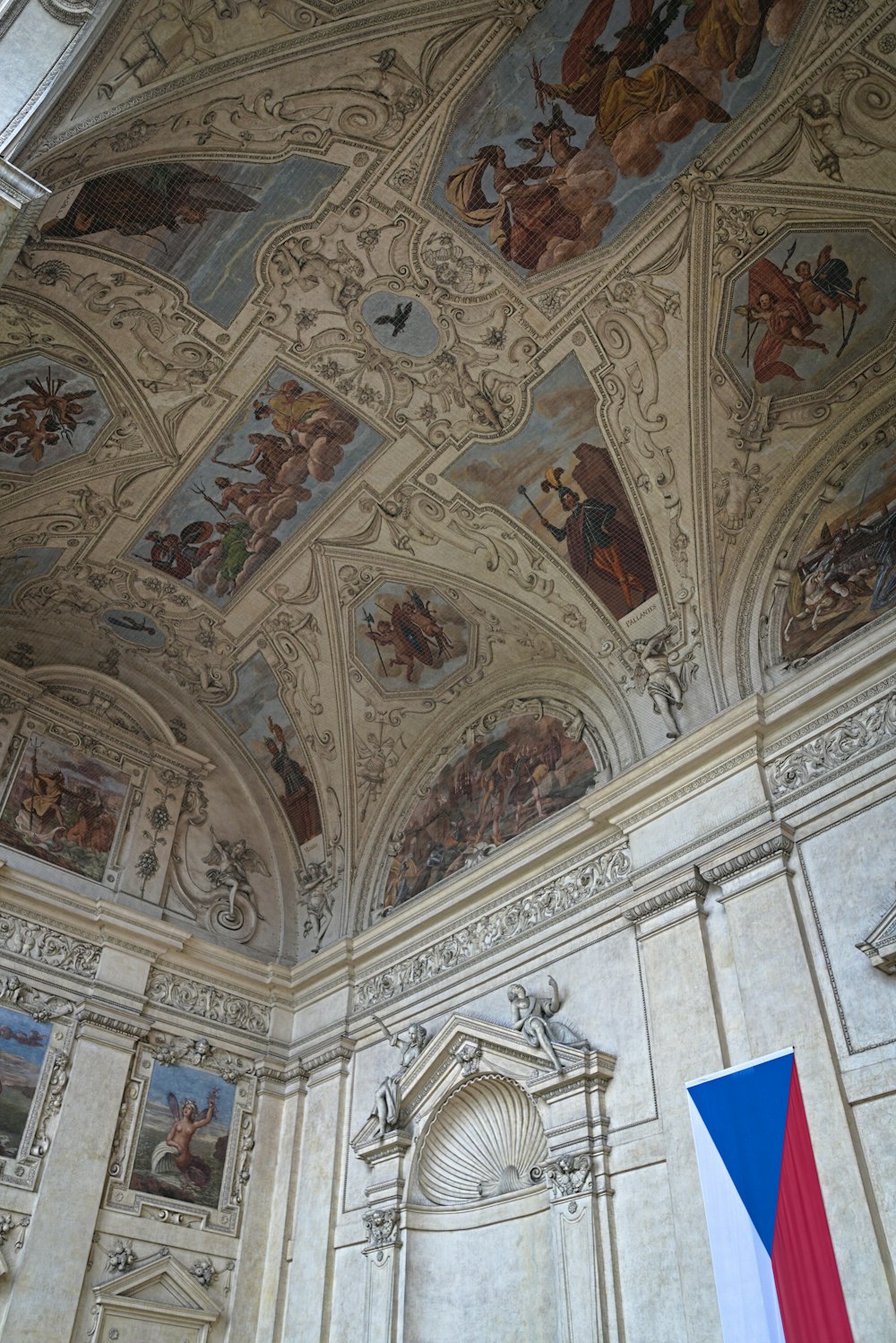 the ceiling of a building with paintings on it