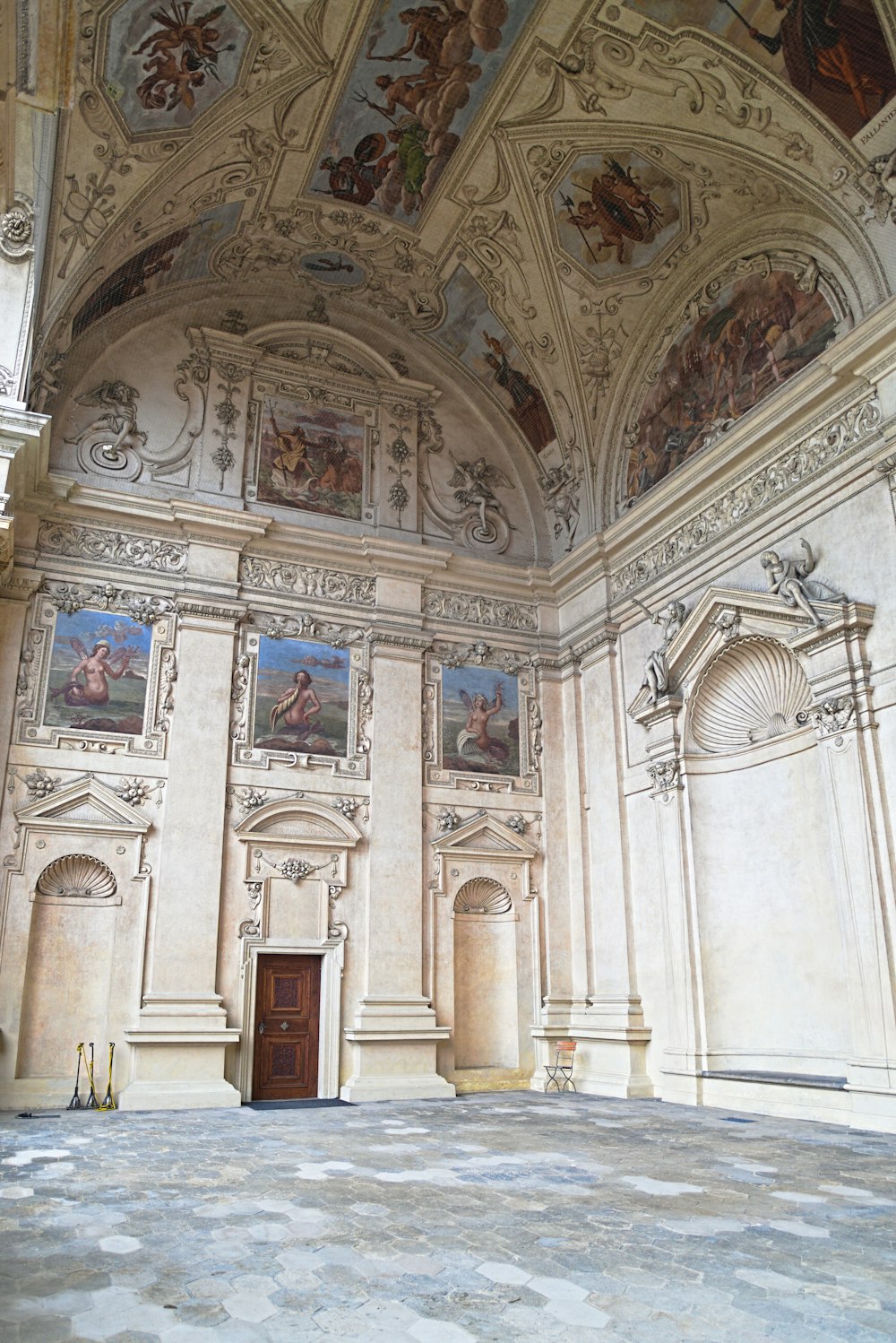 a large room with paintings on the walls