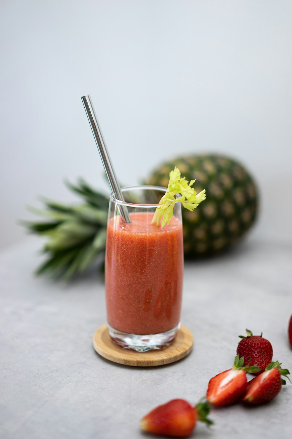 a smoothie in a glass with a straw and garnish