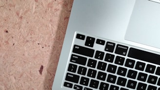 Technician testing a MacBook keyboard and trackpad after repair, ensuring flawless function.