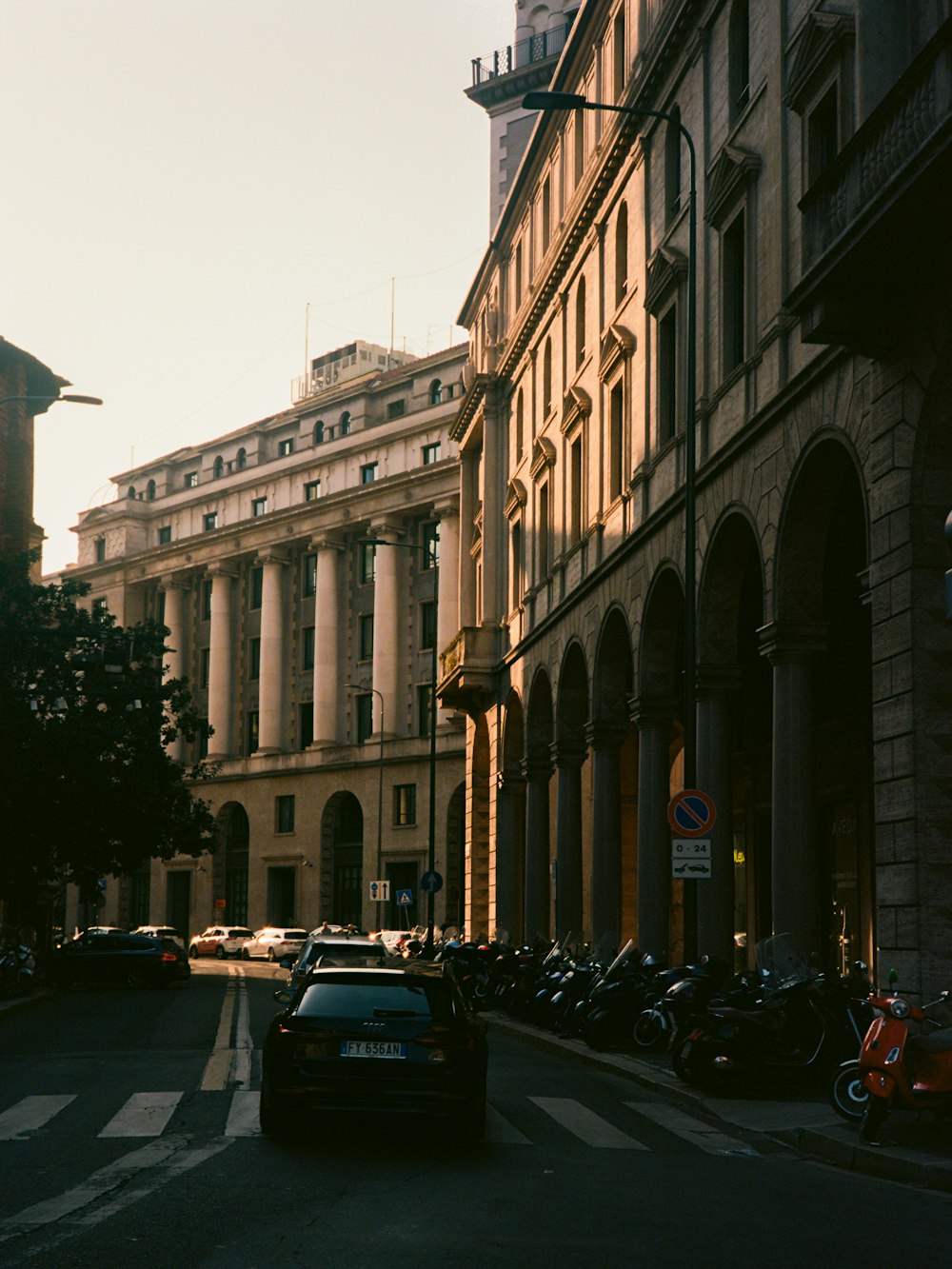 a car driving down a street next to tall buildings