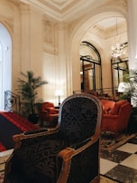 a living room with a checkered floor and a chandelier