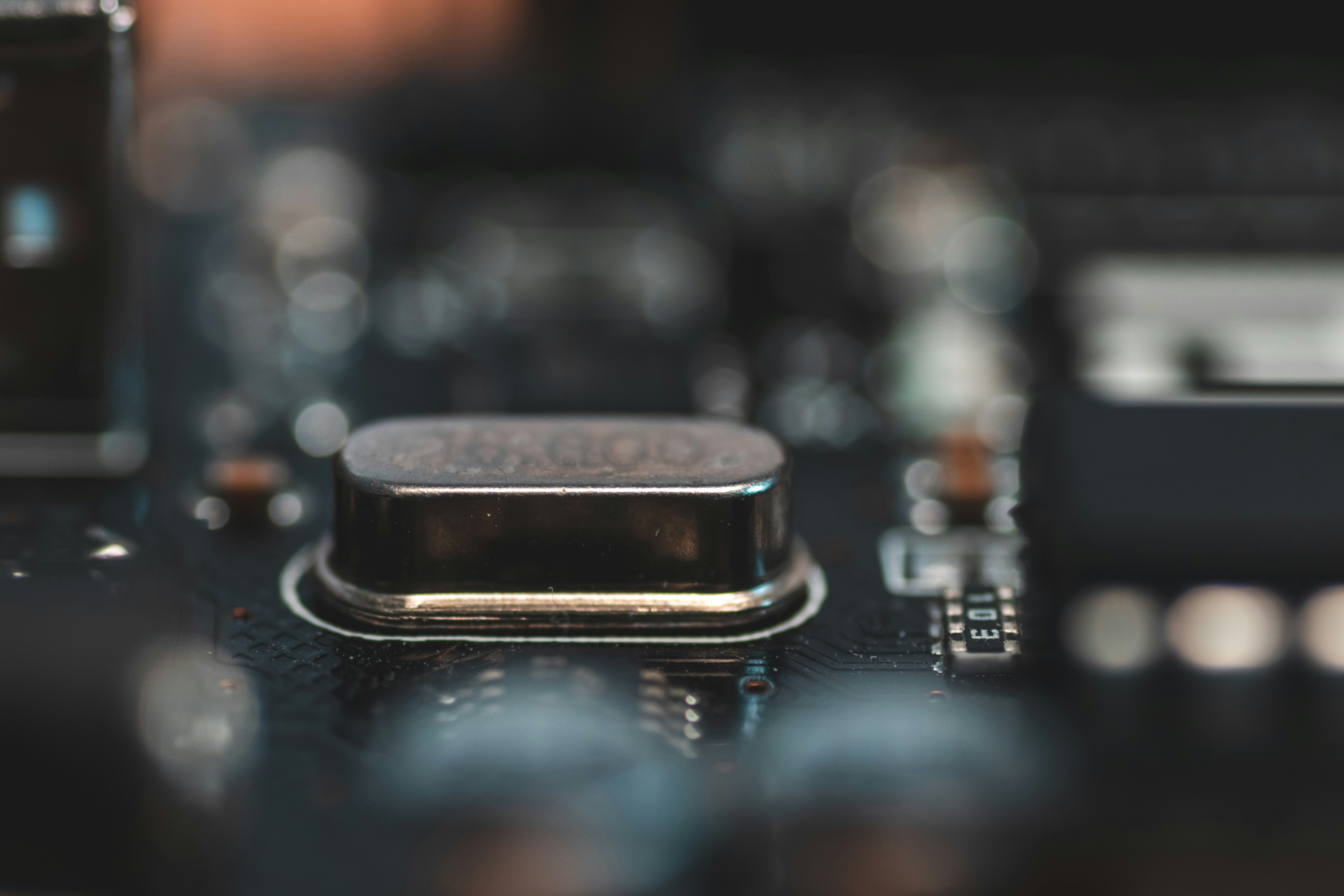 Close-up of a modern computer chip on a circuit board, metallic surface, macro photography, dark background