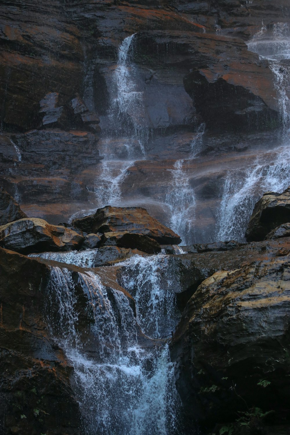 a waterfall is shown in the middle of a rocky area