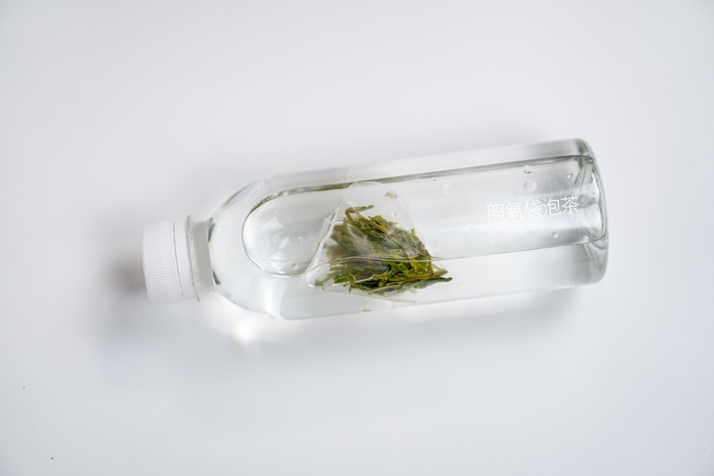 a glass bottle filled with a green substance