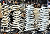 a pile of fish sitting on top of a pile of sand