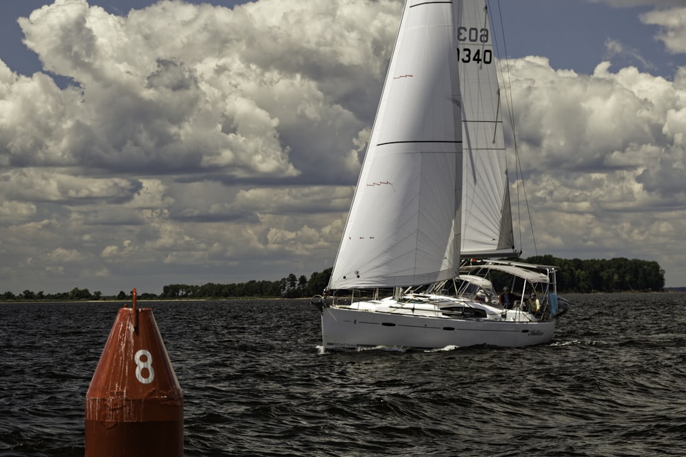 a sailboat sailing on a body of water