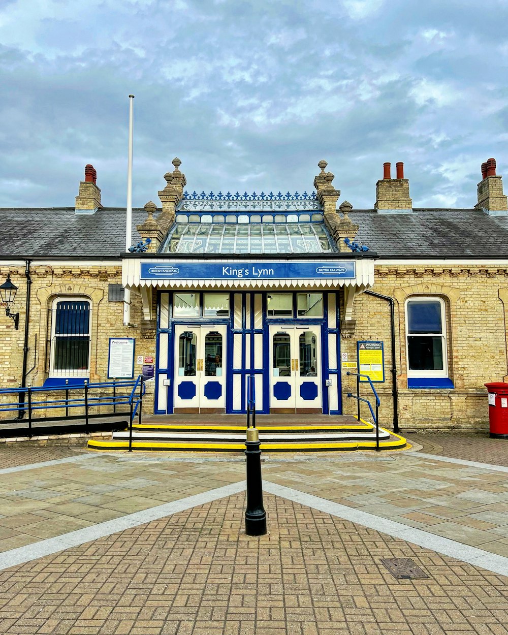 a blue and white train station with a sky background