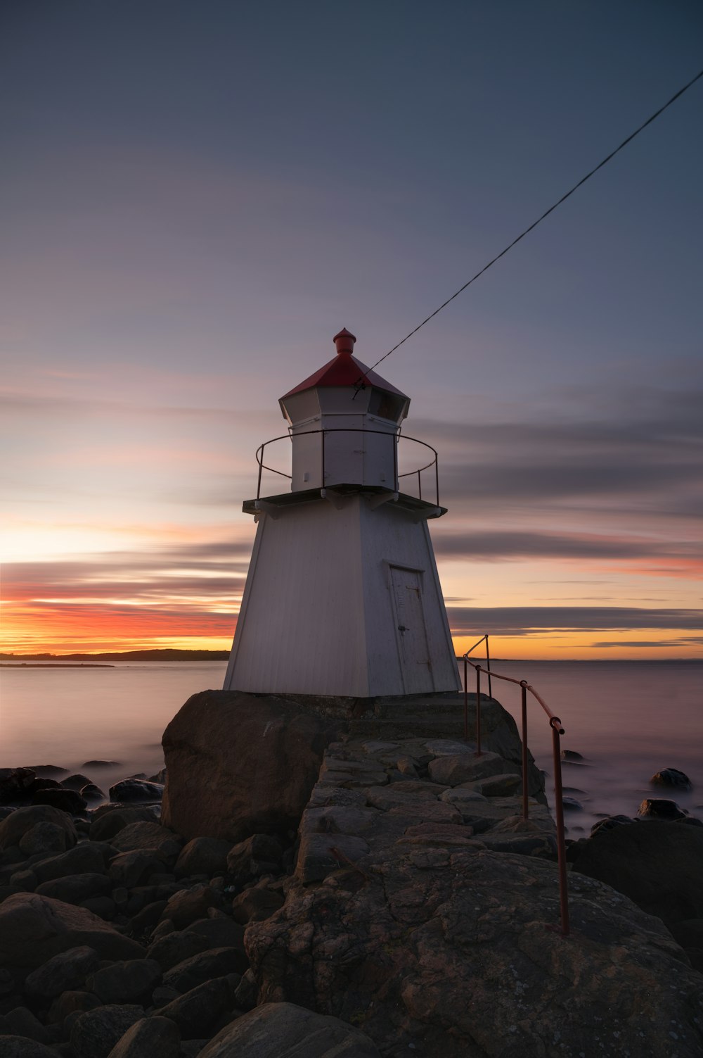 a light house sitting on top of a rocky shore