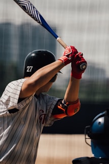 a baseball player holding a bat on top of a field