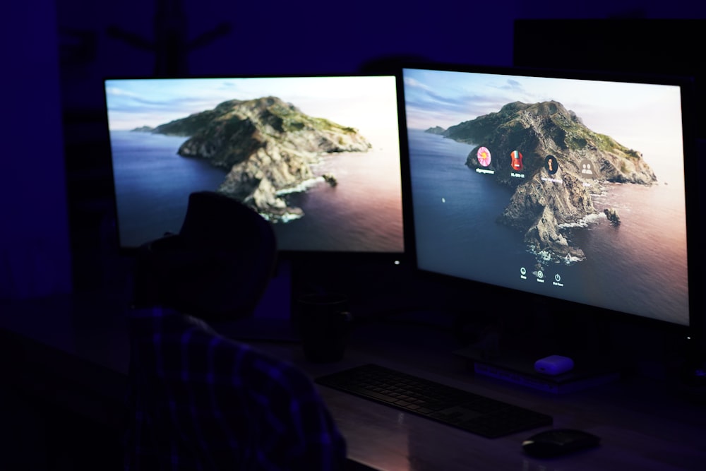 a flat screen tv sitting on top of a computer