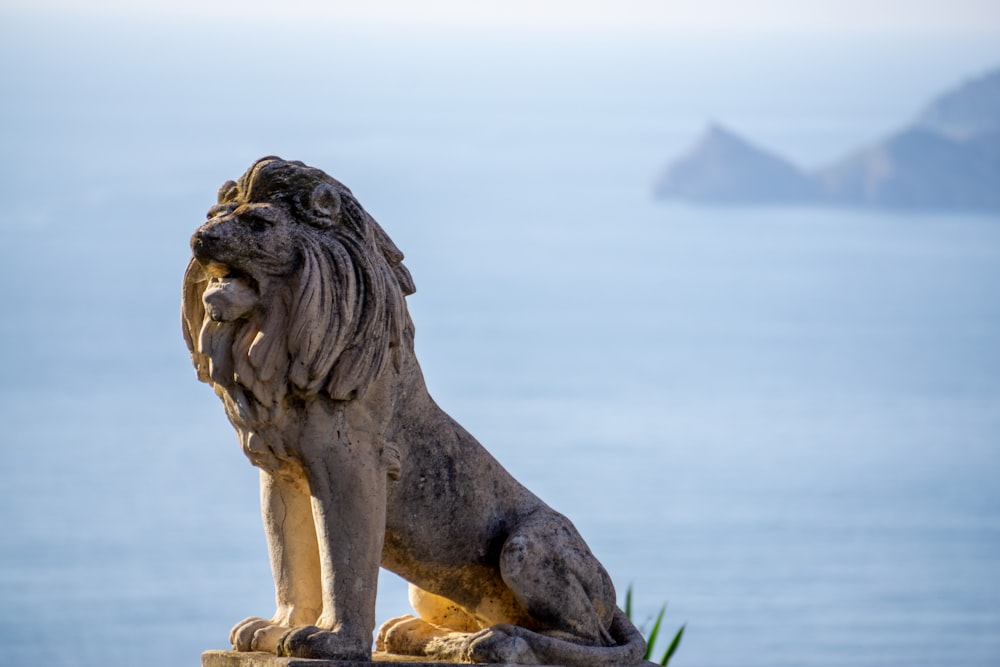 a statue of a lion sitting on top of a rock
