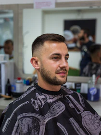a man in a barber shop getting his hair cut
