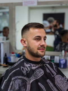 a man in a barber shop getting his hair cut