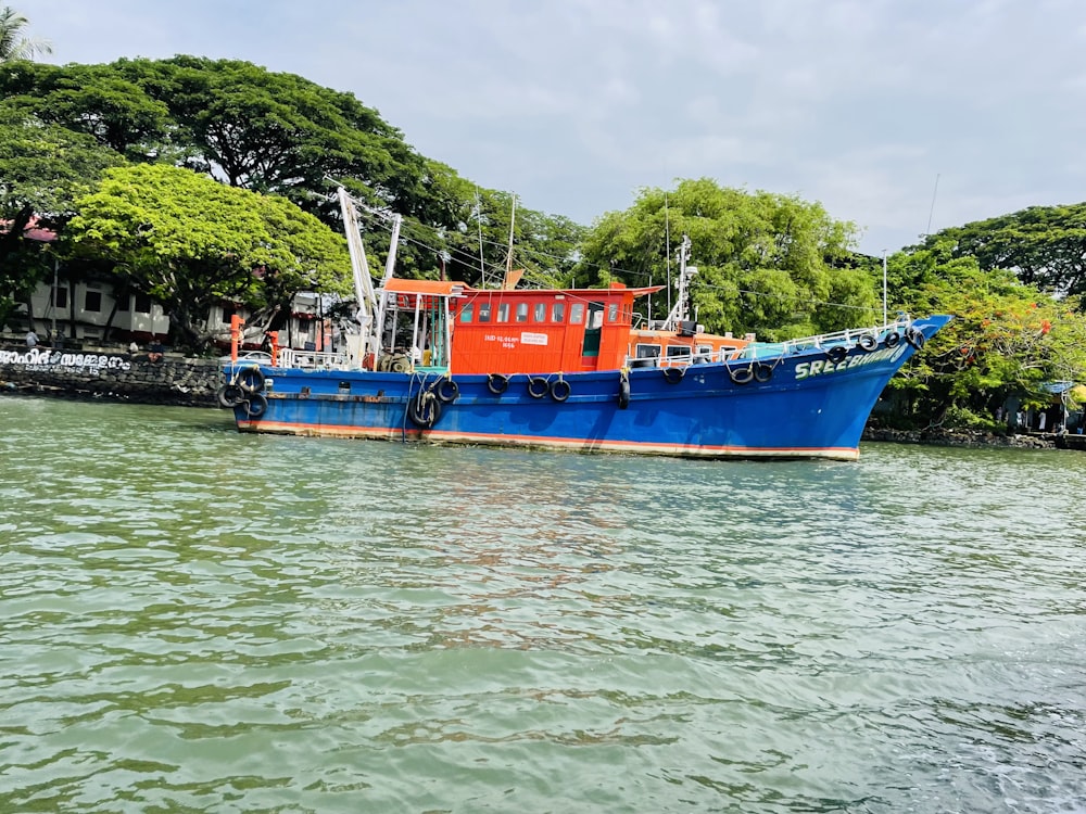 a large blue boat floating on top of a lake