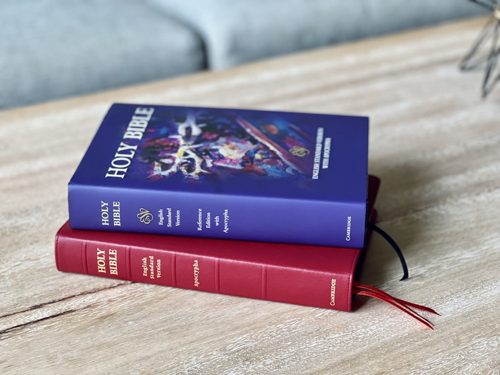 a couple of books sitting on top of a wooden table