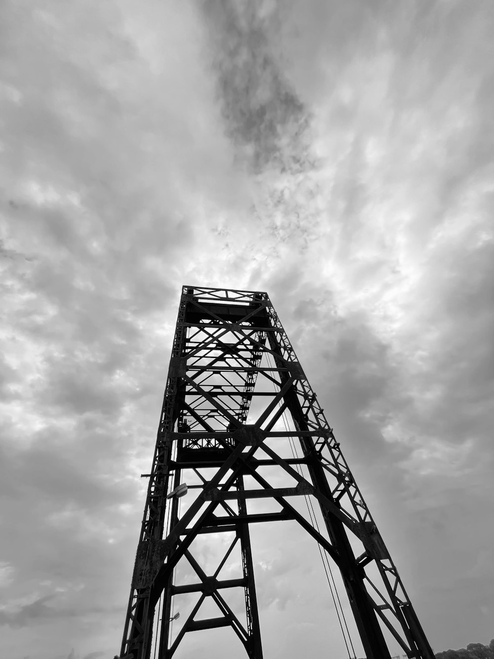 a black and white photo of a tall metal structure
