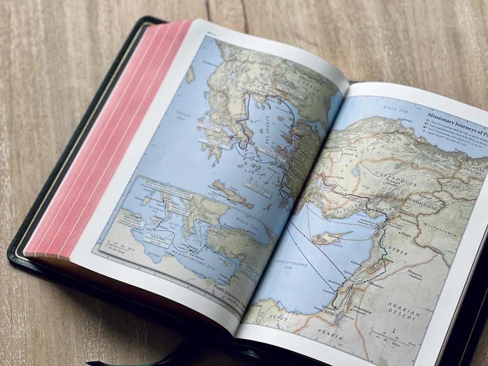 an open book with a map of the world on it