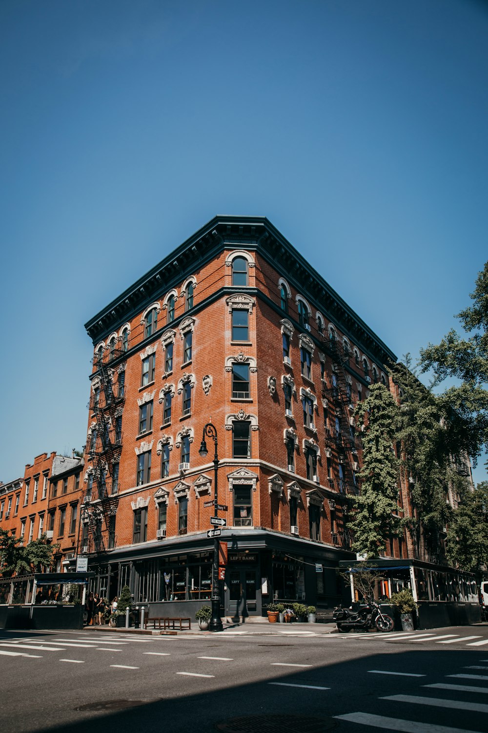 a tall red brick building sitting on the corner of a street