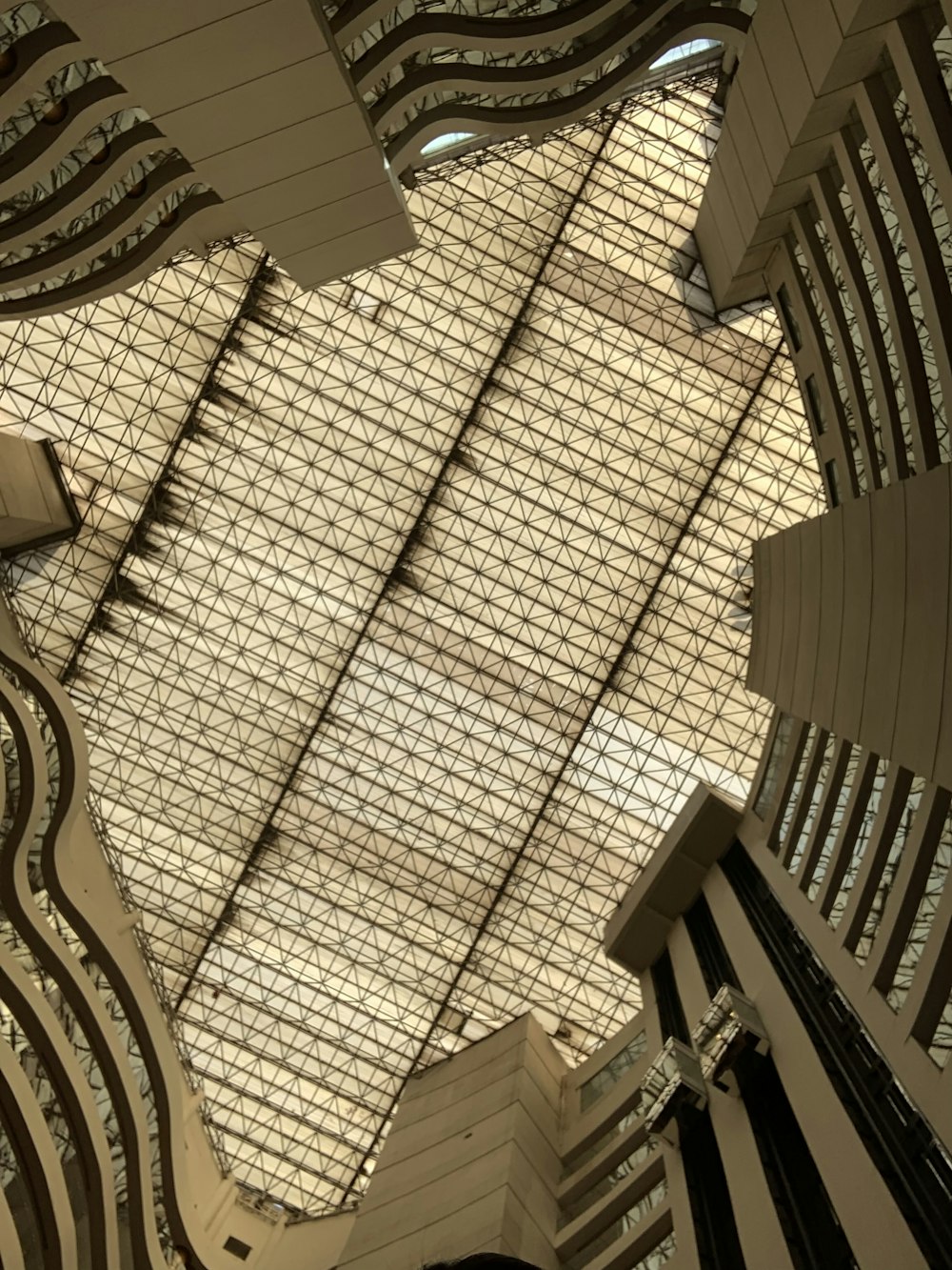 the ceiling of a building with many windows