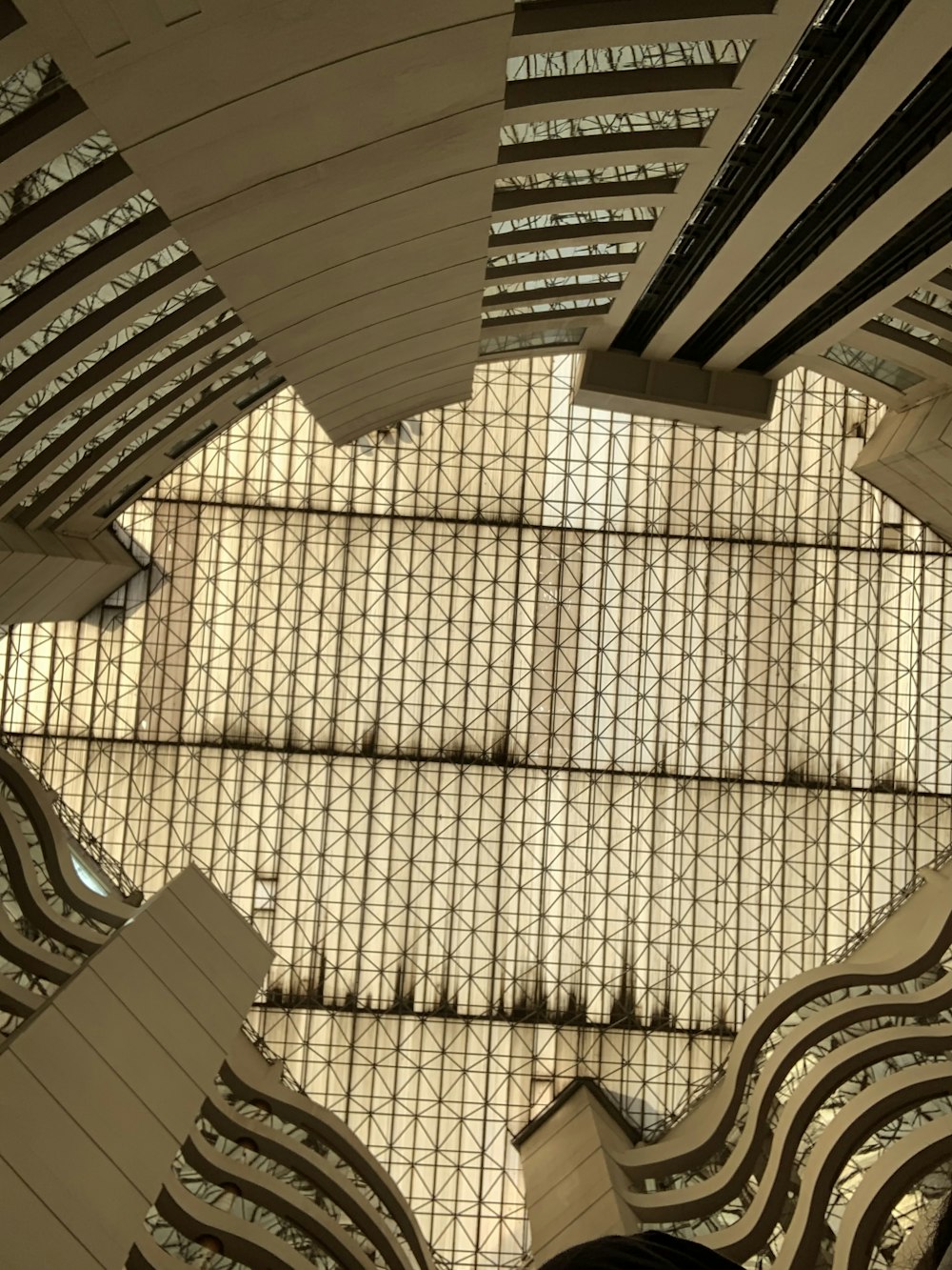 the ceiling of a building with many windows