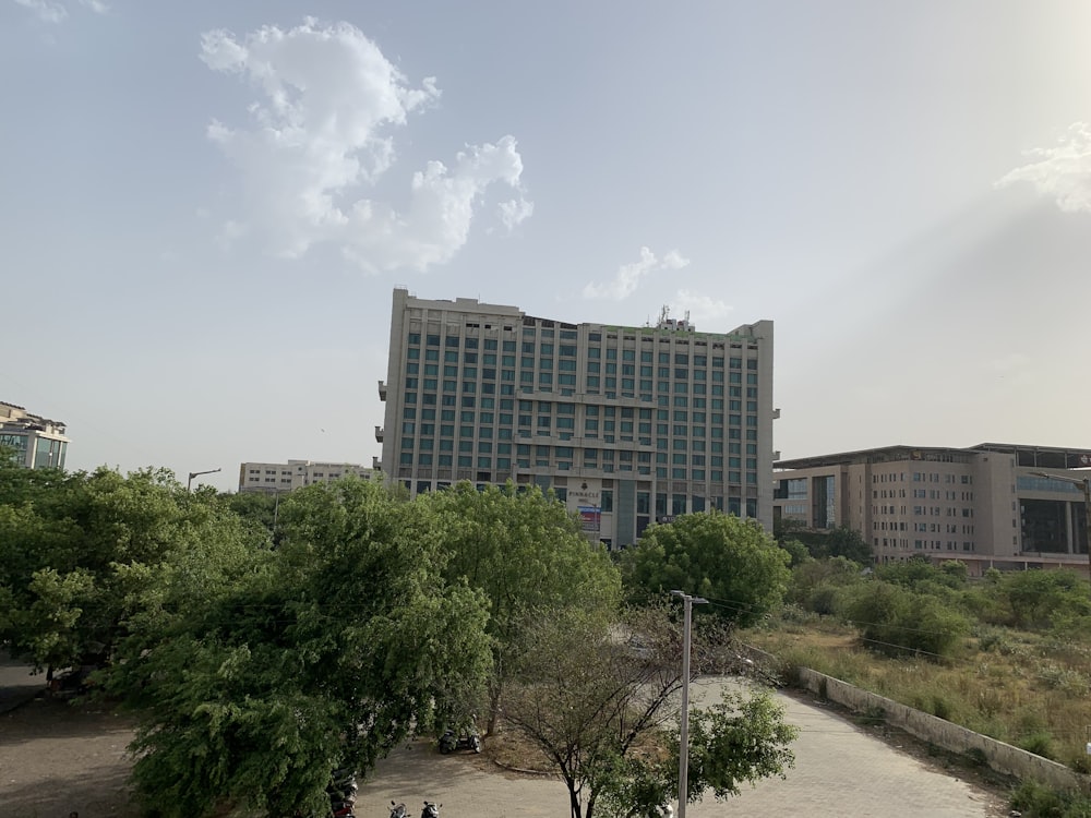 a large building with a lot of trees in front of it