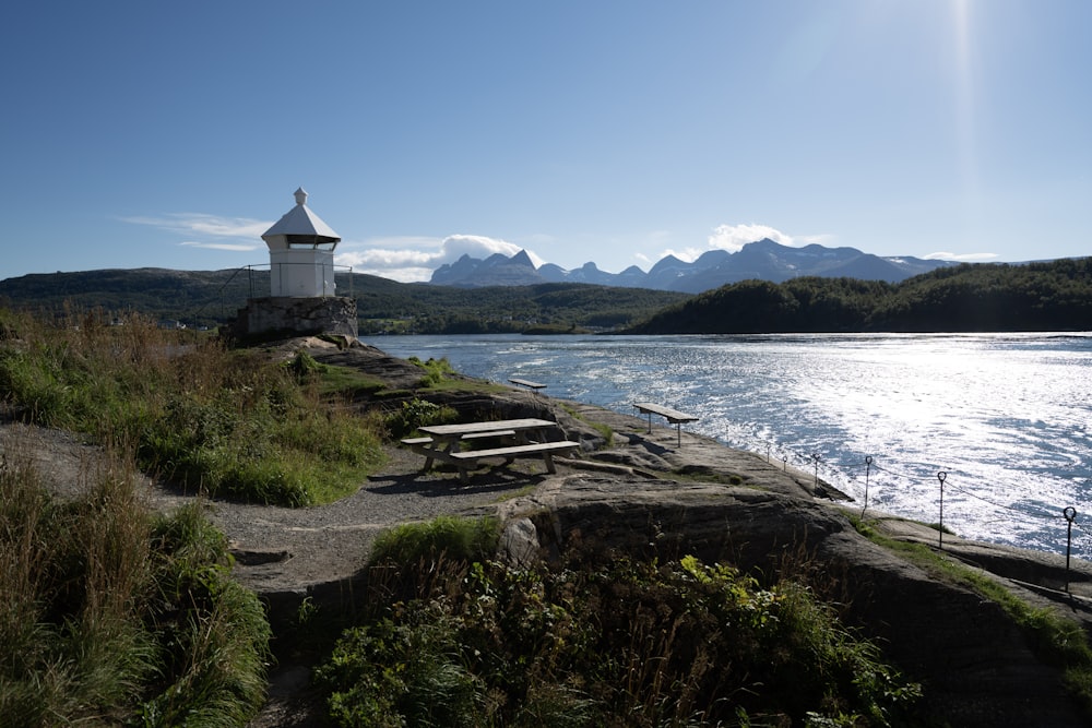 a lighthouse on the edge of a body of water