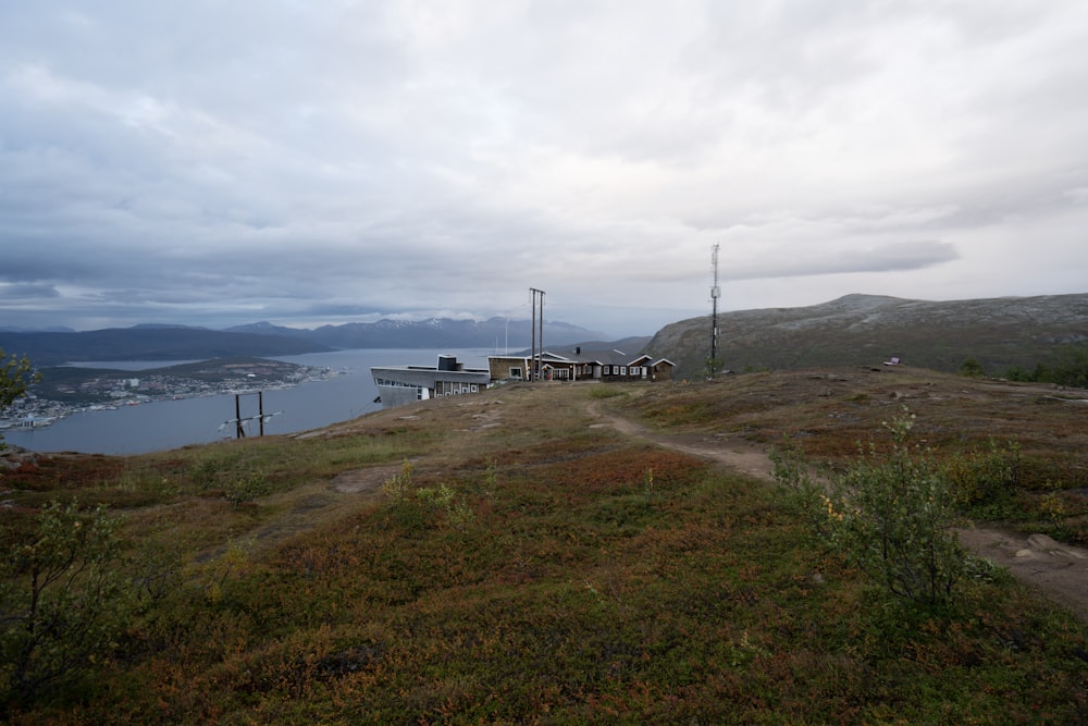 a grassy hill with a body of water in the background