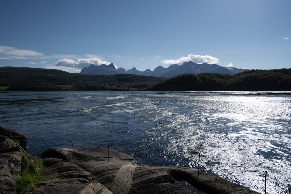 a body of water with mountains in the background