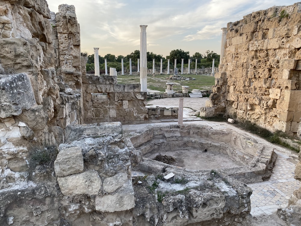 the ruins of a roman city with columns in the background