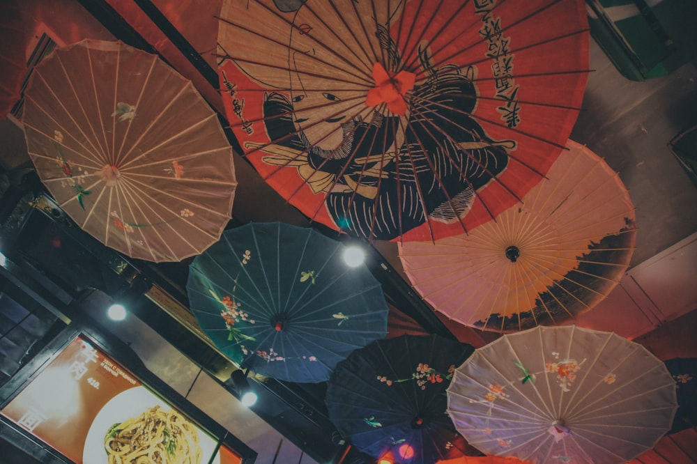 a group of colorful umbrellas hanging from the ceiling