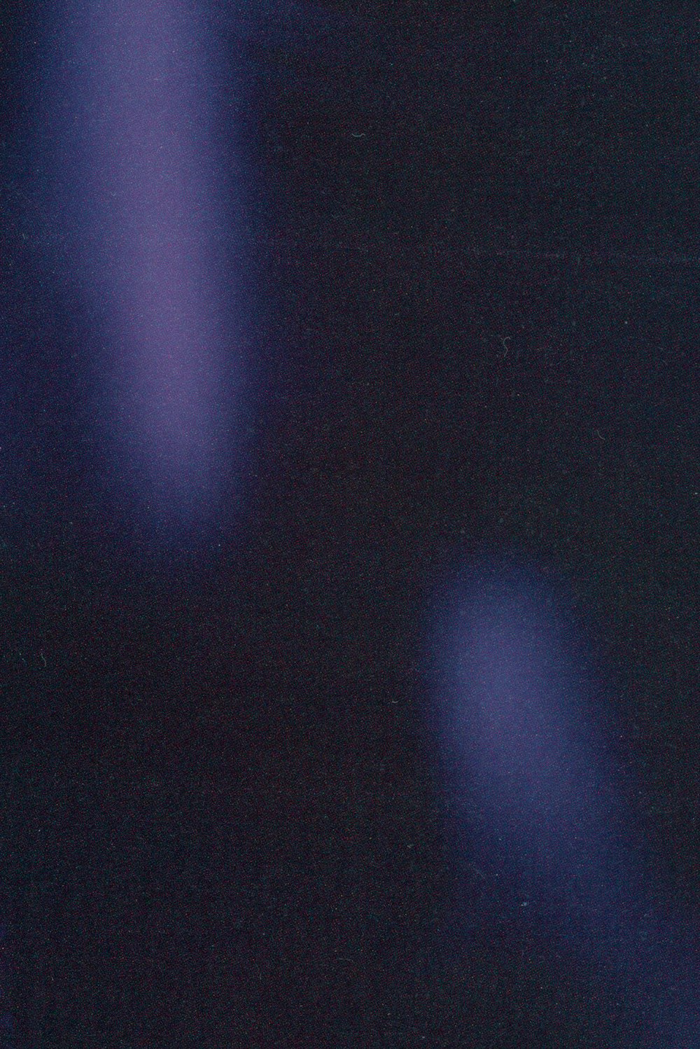 a blurry image of a blue light in the dark