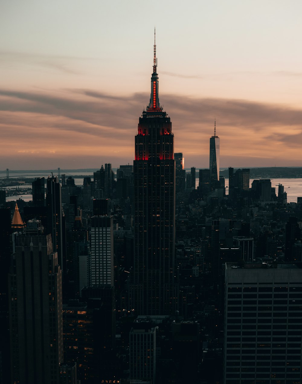 a very tall building with a red light on top of it