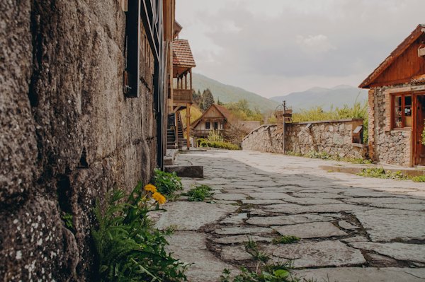 A cobblestone street with a stone building in the background — Dilijan, Armenia