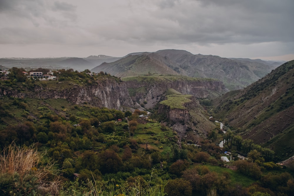 a view of a valley with mountains in the background