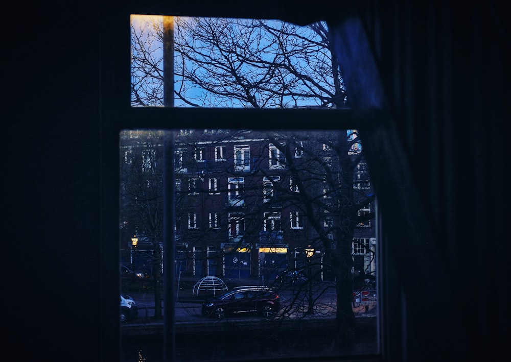 a window with a view of a city at night