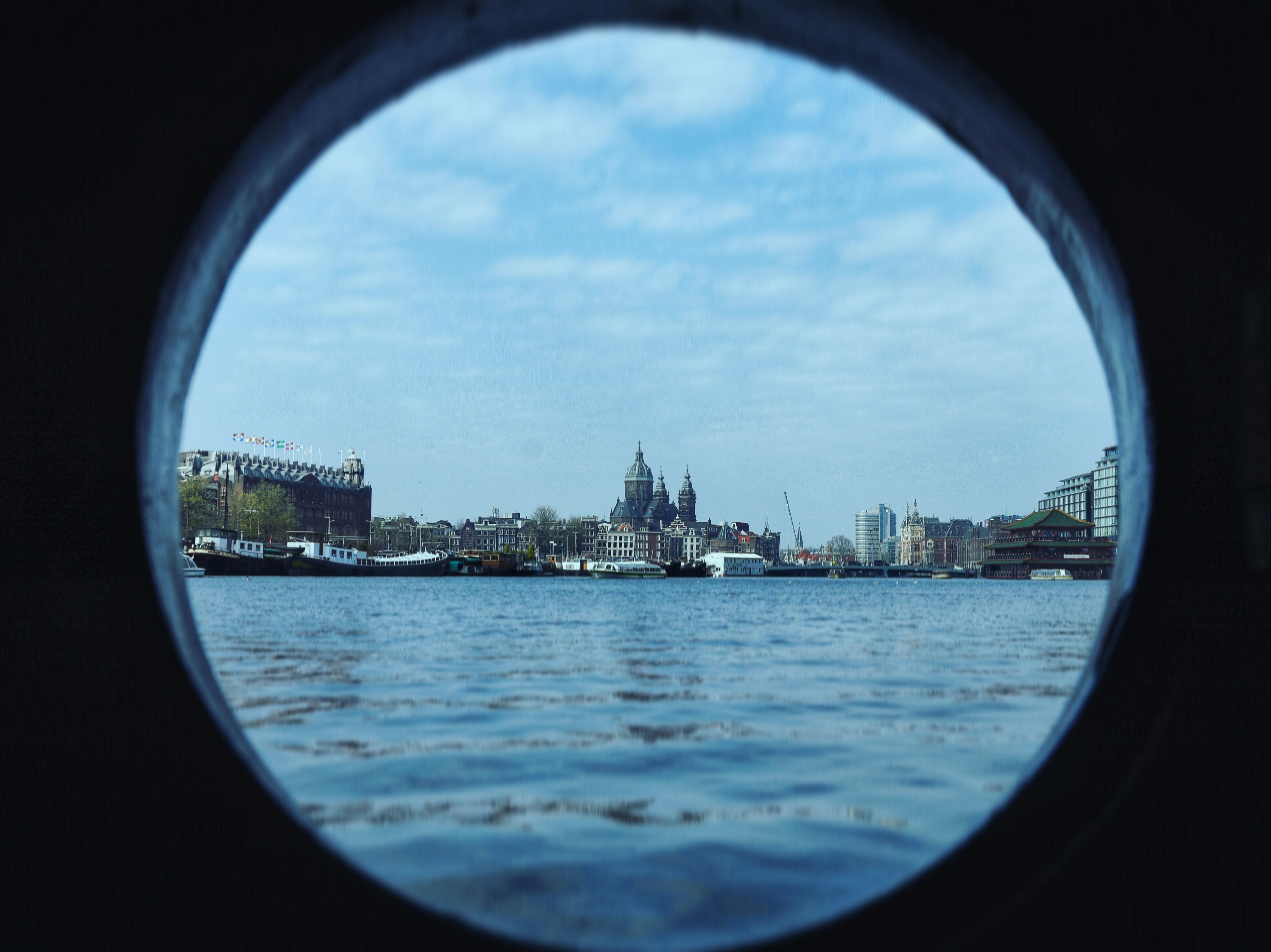 a view of a city from a porthole in the water