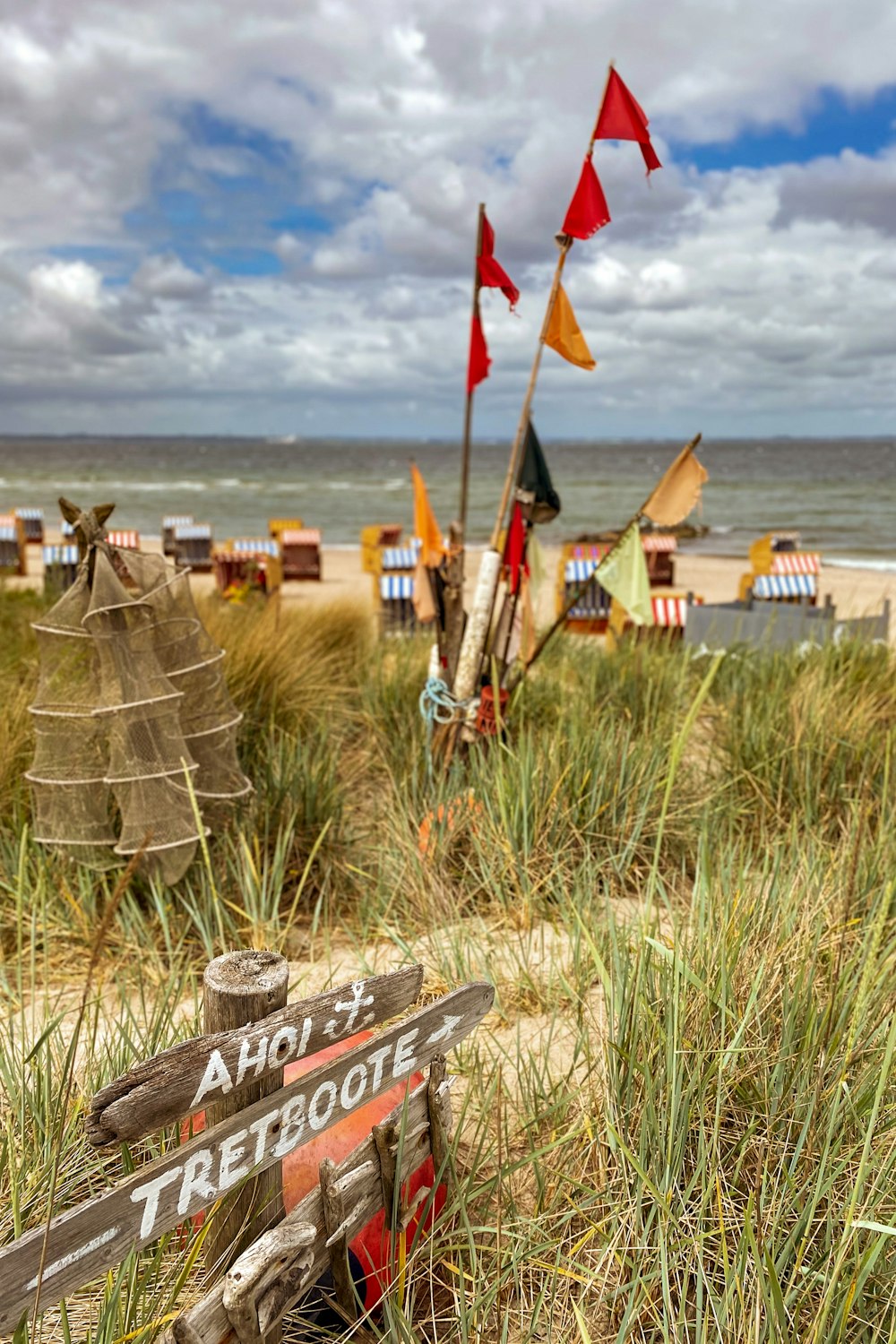 a wooden sign sitting on top of a sandy beach