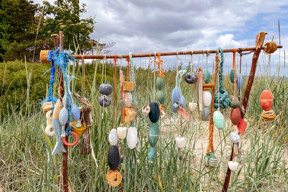 a bunch of items hanging from a wooden pole
